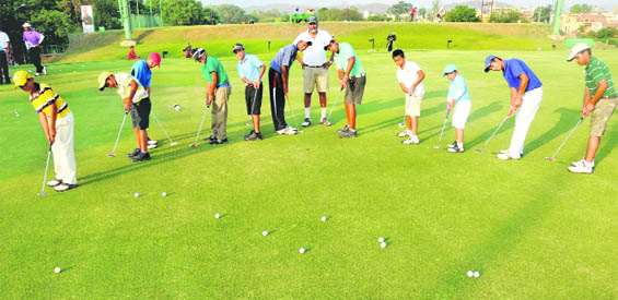 National Golf Academy of India director Jessie Grewal (C) hones the talent of budding golfers at the CGA Range 