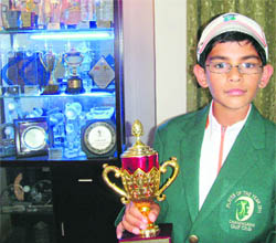 Ten-year-old Aadil Bedi with a cupboard full of trophies at his residence in Chandigarh