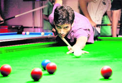 Khem Chand in an effort to pocket a red ball during the ongoing snooker championship in Chandigarh on Saturday