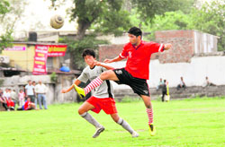 Players in action in a match in the Lala Nemi Dass Memorial District Football League at the Pavilion ground in Dehradun on Saturday.