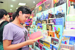 A girl selects a Fathers Day Card at a shop in Dehradun on Saturday. 
