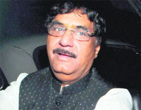 BJP leader Gopinath Munde leaves after meeting senior BJP leaders Venkaiah Naidu and Ananth Kumar in New Delhi on Saturday.