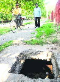An open manhole exposes the apathy of the MC.