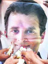 Congress workers offer cake to a poster of Rahul Gandhi on his 41st birthday in Allahabad on Sunday.