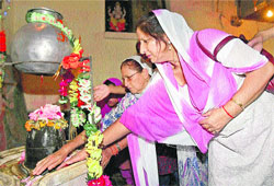 Kashmiri Pandit women offer prayers at Sheetleshwar Bhairav Temple in Srinagar on Sunday. 