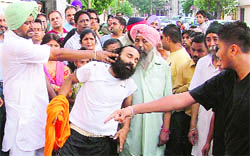 Jagdeep Singh, a house-owner, being beaten up by residents of Ghumar Mandi in Ludhiana on Sunday