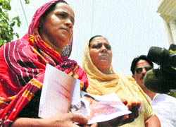 Amarjeet Kaur (left) shows photographs of her wounds to the media in Ludhiana on Sunday