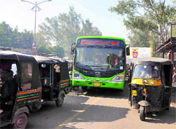 The bus on trial run jostles with auto-rickshaws for space near Durga Mata Mandir in Ludhiana