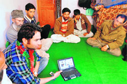 Raja holds a group discussion with the villagers
