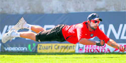 Virat Kohli takes a diving catch during a practice session in Kingston, Jamaica, on Saturday. The first Test of the three-match series between India and the West Indies starts on Monday