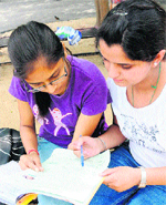 Students fill in forms at a government college in Chandigarh