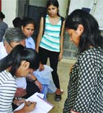 Students fill in forms at a college in Delhi University