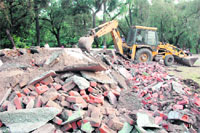 The dais at Gandhi Park being razed by the Municipal Corporation staff.