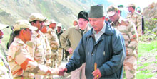 Uttarakhand Chief Secretary Subhash Kumar shakes hands with a jawan of the Indo-Tibetan Border Police during his visit to the border areas of Pithoragarh district.