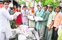 Members of Madhya Pradesh-based NGO Sangani Group and the Tehreek-e-Insaaf distribute relief material among terrorism-affected families at Mubarak Mandi in Jammu on Monday.