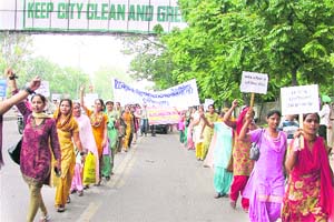 Inclusive education volunteers hold a protest rally in Ludhiana on Monday.