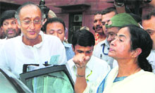 West Bengal Chief Minister Mamata Banerjee with state minister Amit Mitra comes out after meeting Union Finance Minister Pranab Mukherjee at North Block in New Delhi on Monday.