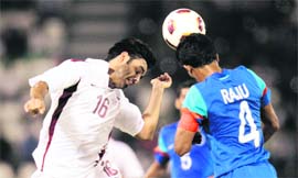 Qatar's Abdulaziz Al-Ansari (L) and India's Raju Gaikwad vie for the ball in their match in Doha on Sunday. 