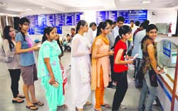 Girls line up to deposit fee at a counter of the State Bank of India in Panjab University, Chandigarh
