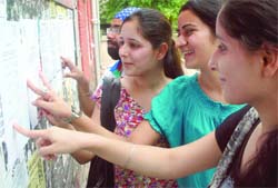 Students check the second cut-off list at Hindu College in New Delhi on Tuesday.