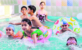 With the mercury rising, children enjoy themselves in a swimming pool in Dehradun on Tuesday. 