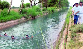 Divers look for the bodies of two minor sisters who drowned in the Nohar canal at Chopta in Sirsa.