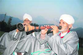 Artistes play traditional musical instruments in a village in Kashmir.