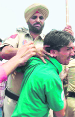 Cops lathicharge a PRTC staff member in Patiala on Tuesday