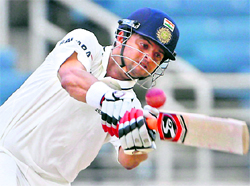 Suresh Raina plays a shot against the West Indies in Kingston, Jamaica on Monday. Raina scored 82 as India folded for 246 in the first innings