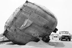 An overloaded paddy trailer overturns on the Chandigarh-Ambala highway in Dera Bassi on Wednesday. 