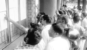 Slum dwellers check their names during the draw of lots at HUDA complex in Sector 6, Panchkula, on Wednesday. 