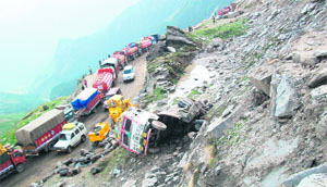 The remains of a truck that fell down at the landslide-prone Rani Nullah