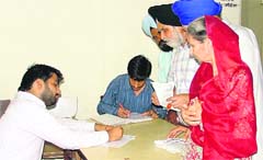 Queuing-up for a cause People coming from far-off places line up for forms to get their unique IDs made in Ludhiana