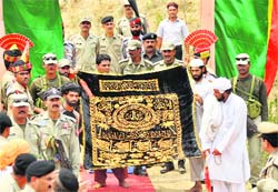 Pakistan Rangers carry a holy chaddar to offer at the shrine of Baba Chamliyal on the border in Samba district