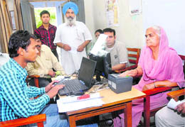 An aged woman gets herself registered for the unique identification card (Aadhar) in Jalandhar. 