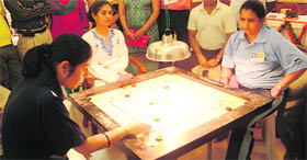 A player plays a shot during the final match of the LIC North Zone Carrom Tournament at Sector 24 in Chandigarh on Friday. 
