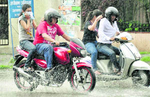 Residents on two wheelers get drenched in Dehradun 
