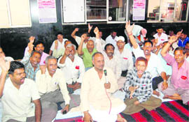 Railway employees hold a protest at Dehradun railway station 