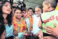 Released sailors NK Sharma (L) and Prashant Chauhan (2nd from right) arrive at the Indira Gandhi International Airport in New Delhi