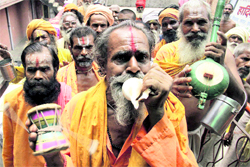 Sadhus wait for their turn to register themselves for the Amarnath yatra at a registration office in Jammu on Friday