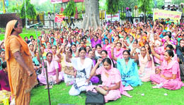 ASHA workers protest against health department at the mini-secretariat in Ludhiana on Friday.