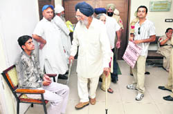Darshan Singh, an NRI, walks out of the DC office after attending an open darbar in Ludhiana on Friday.