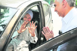 AK CHopra, Additional Controller of Defence Accounts, New Delhi, greets a pensioner, Hardev Singh, during an adalat in Ludhiana on Friday. 