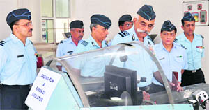 Air Marshal Dhiraj Kukreja, AOC-in-C, Training Command (centre), inspects the MiG-29 cockpit simulator during his visit to the Air Force High Grounds near Chandigarh