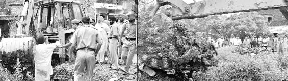 (Left) A person trying to stop MC staff from opening a drain is taken away by the police at Kumbra village in Mohali on Saturday; (Right) MC staff clears blocked sewerage as villagers look on