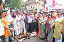 BJP workers stage a protest against the hike in the prices of petroleum products, in Dehradun
