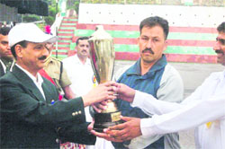 PK Dhasmana, DIG (Training), ITBP (left), presents a trophy at the Inter-Frontier Karate Championship at the ITBP grounds in Mussoorie on Saturday. 