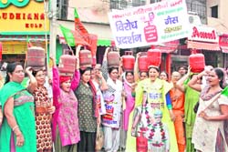BJP activists hold a protest against the hike in petroleum products at Rohtak
