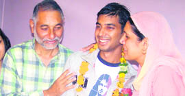 Prashant Chauhan with his parents at his residence in Shimla 