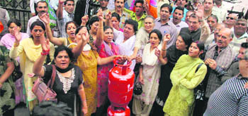 BJP activists raise slogans during a protest against hike in fuel prices in Shimla